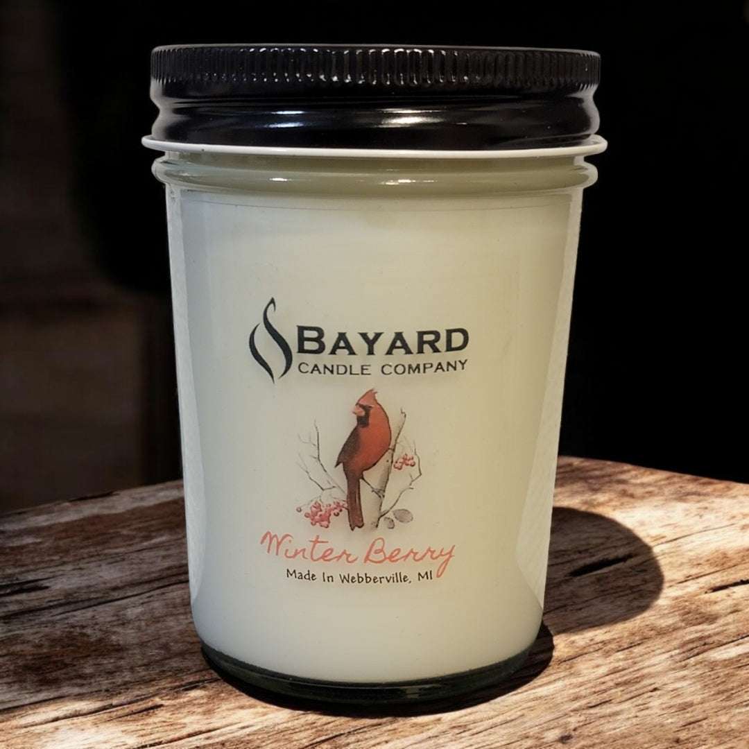 Winter Berry soy candle on a wood table