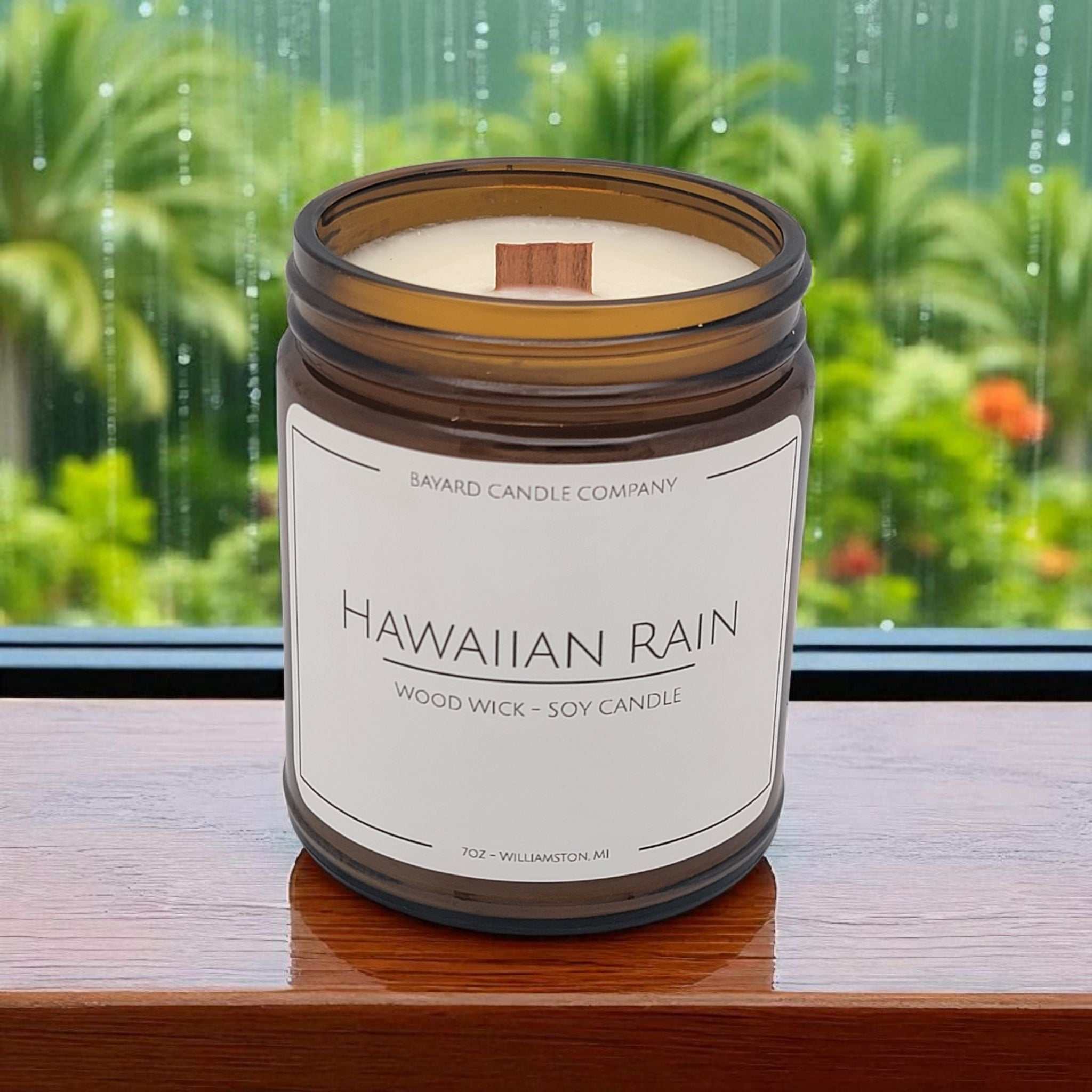 Hawaiian Rain Wood Wick Candle by a rainy window in Hawaii