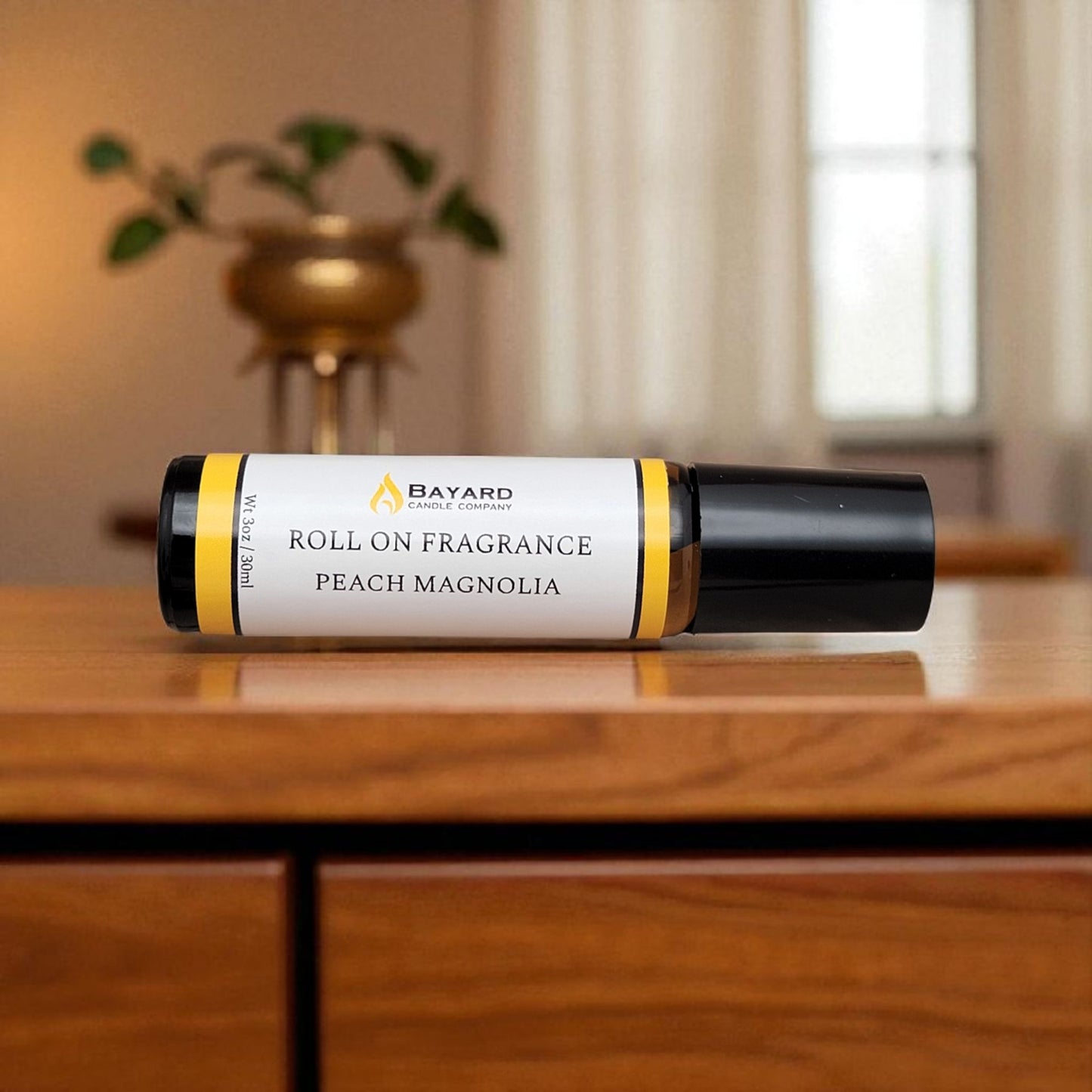 Peach Magnolia Roll On Fragrance on a dresser