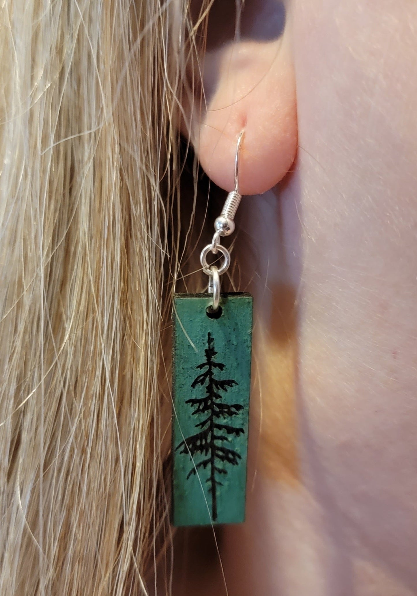 Norwegian Pine Wood Earrings on a woman