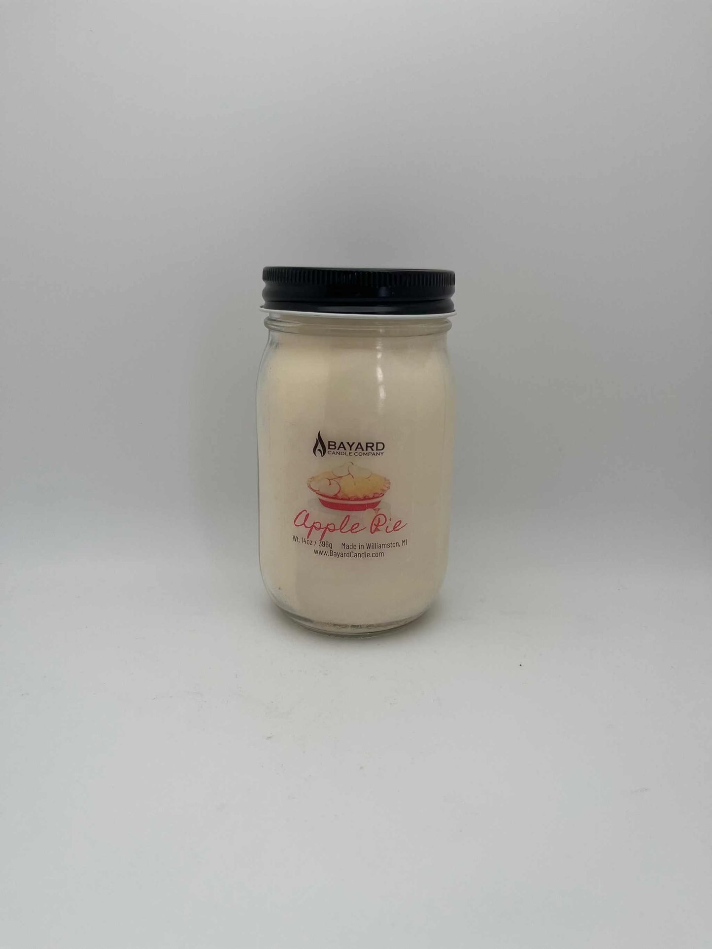 Jar of yogurt with a black lid on a white background
