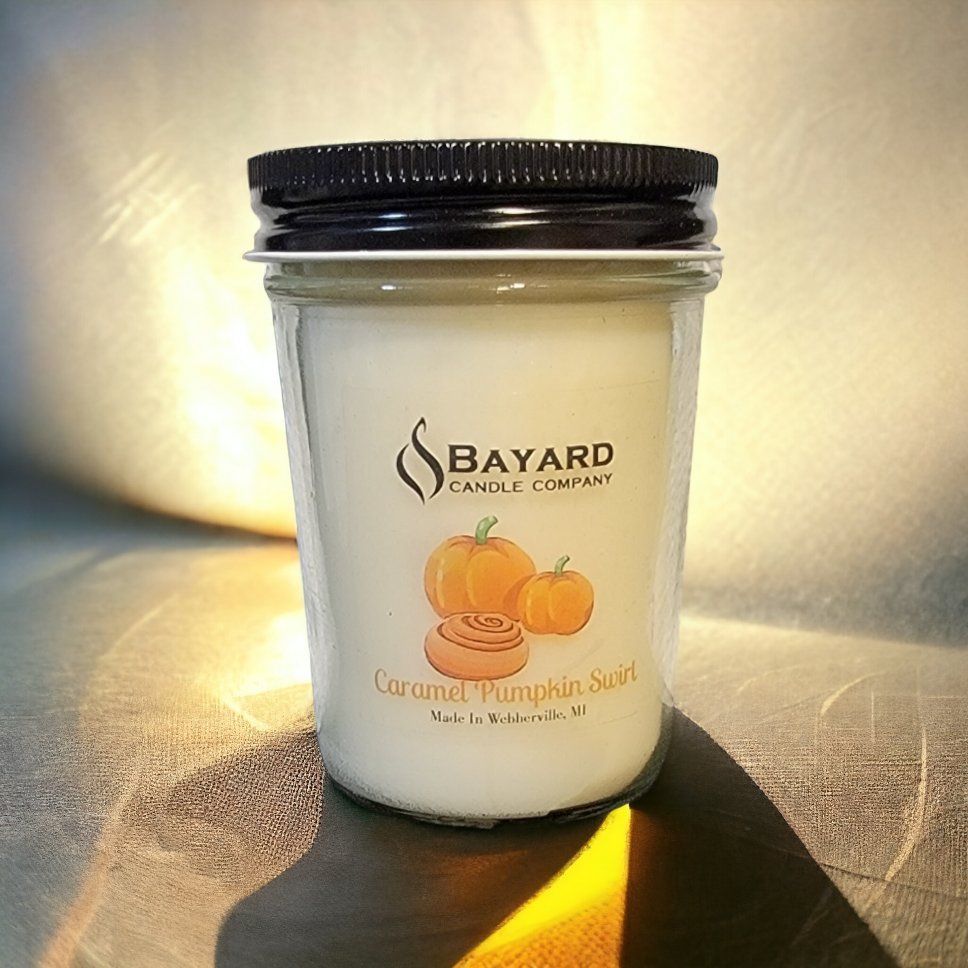 Caramel Pumpkin Swirl Soy Candle in golden light