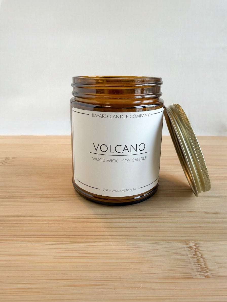 Bayard Candle Company Volcano wood wick soy candle in amber jar with a citrus tropical scent.
