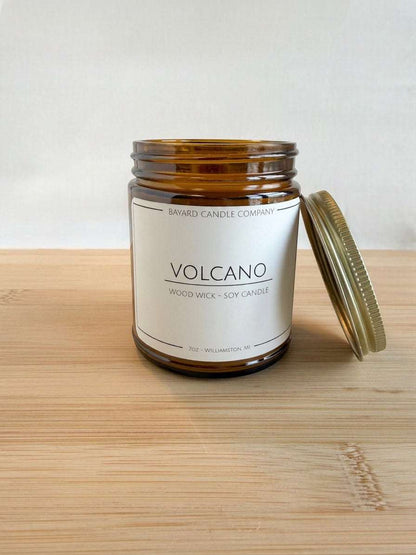 Bayard Candle Company Volcano wood wick soy candle in amber jar with a citrus tropical scent.