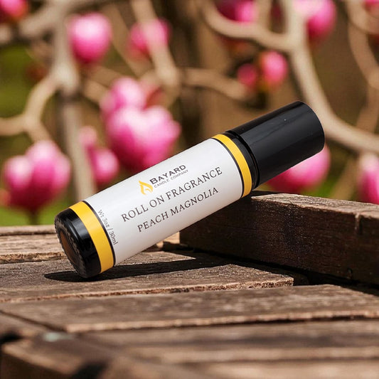 Peach Magnolia Roll On Fragrance on a wood bench