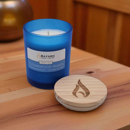 Frosted Cedarwood Amber Soy Candle on a wood table 