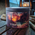 A round metal candle tin labeled &