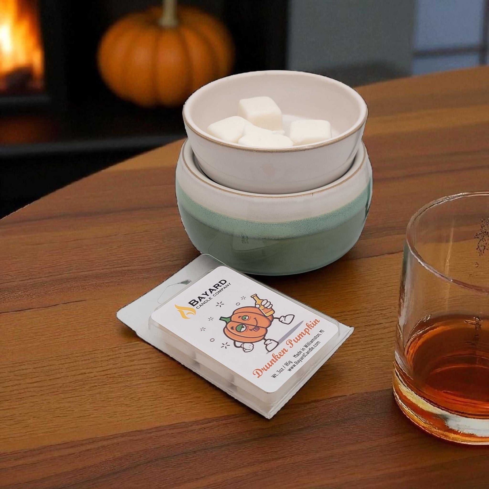 Drunken Pumpkin Soy Wax Melt on a table with a Wax warmer