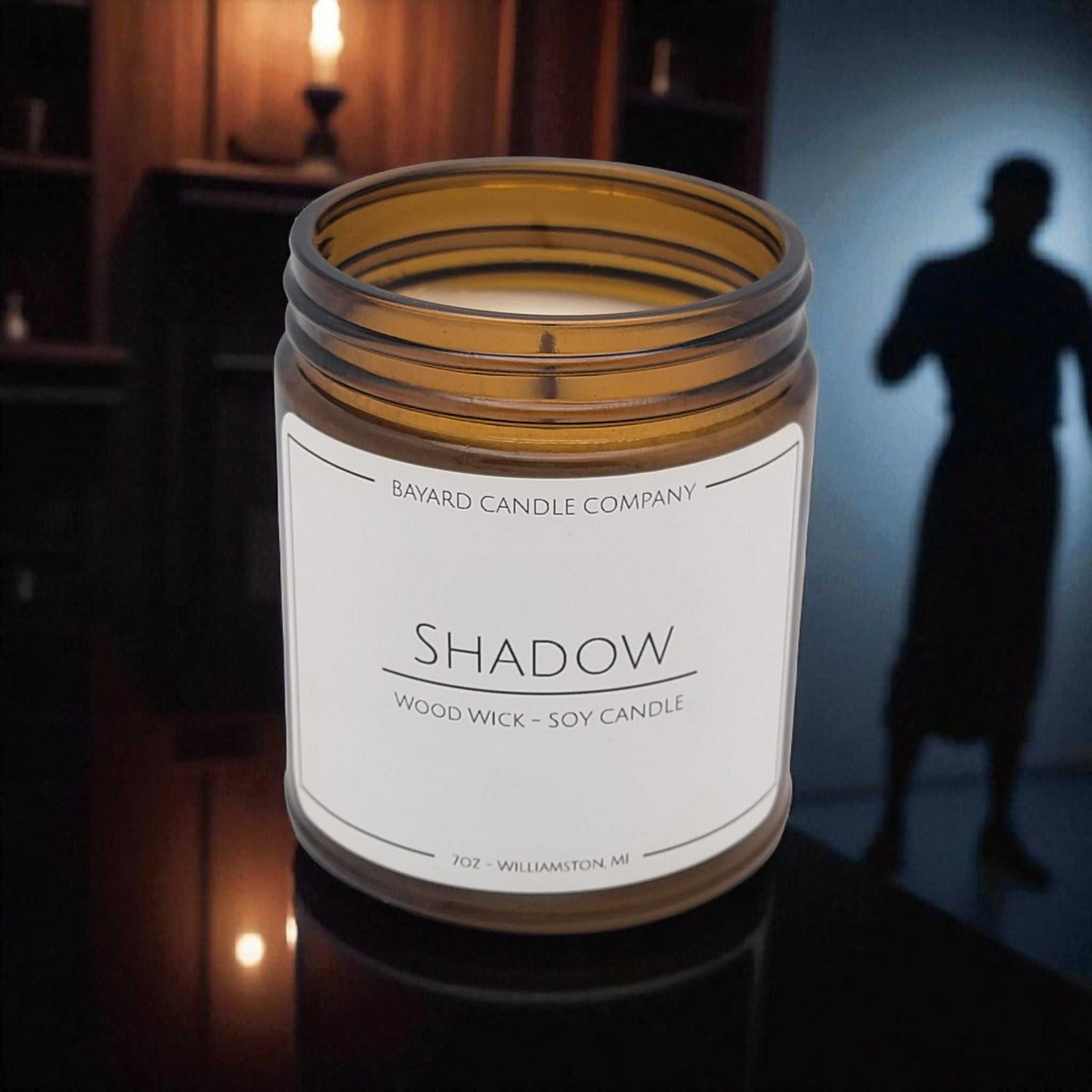 Shadow Wood Wick Candle on a dresser 