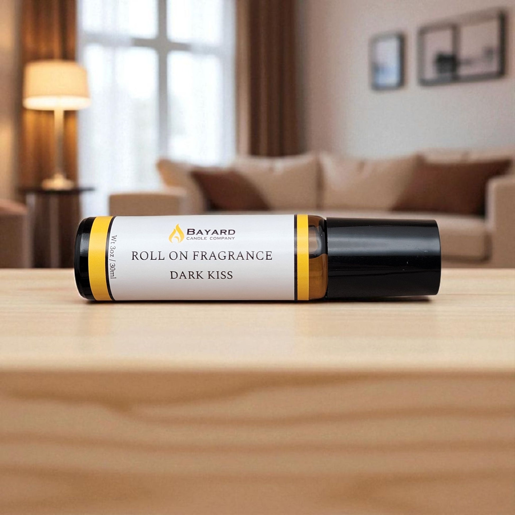 Dark Kiss Roll On Fragrance on a coffee table 