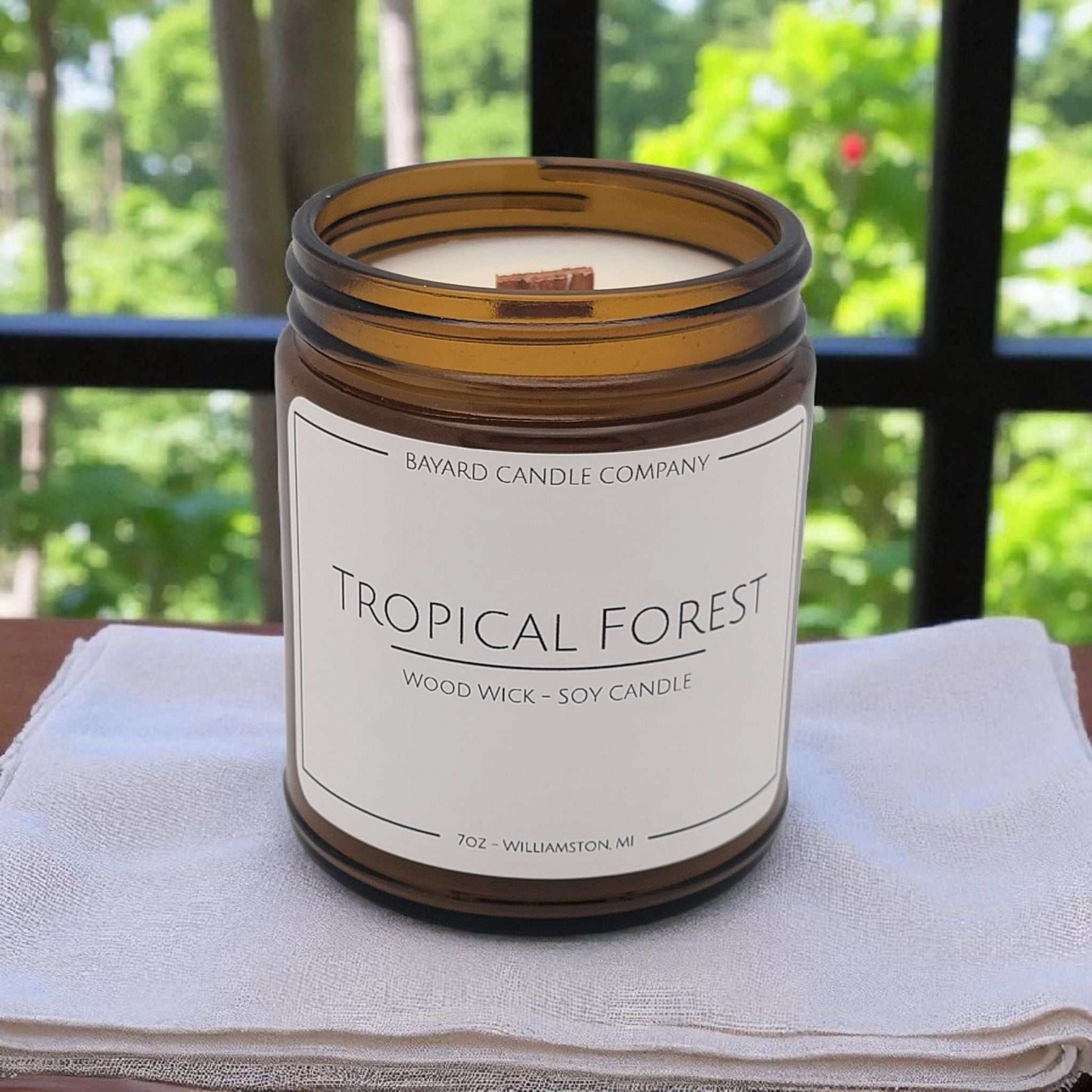 Tropical Forest Wood Wick Candle on a white table