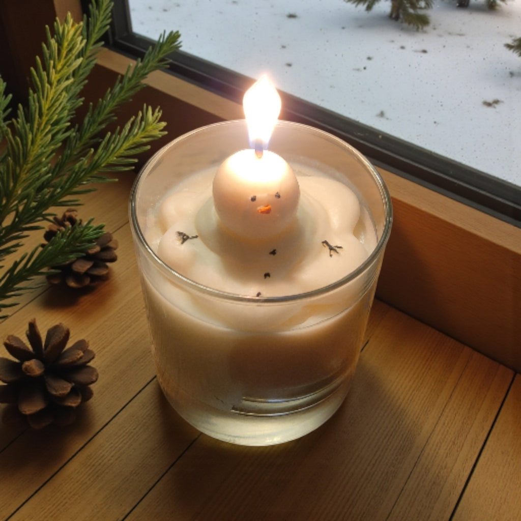 Melting Away Snowman Candle lit on a window sill 