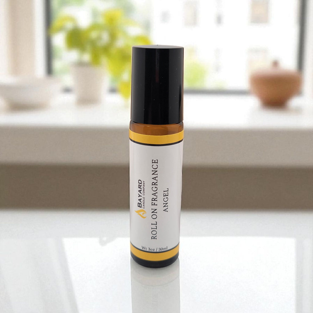 Angel Roll On Fragrance on counter by a window 