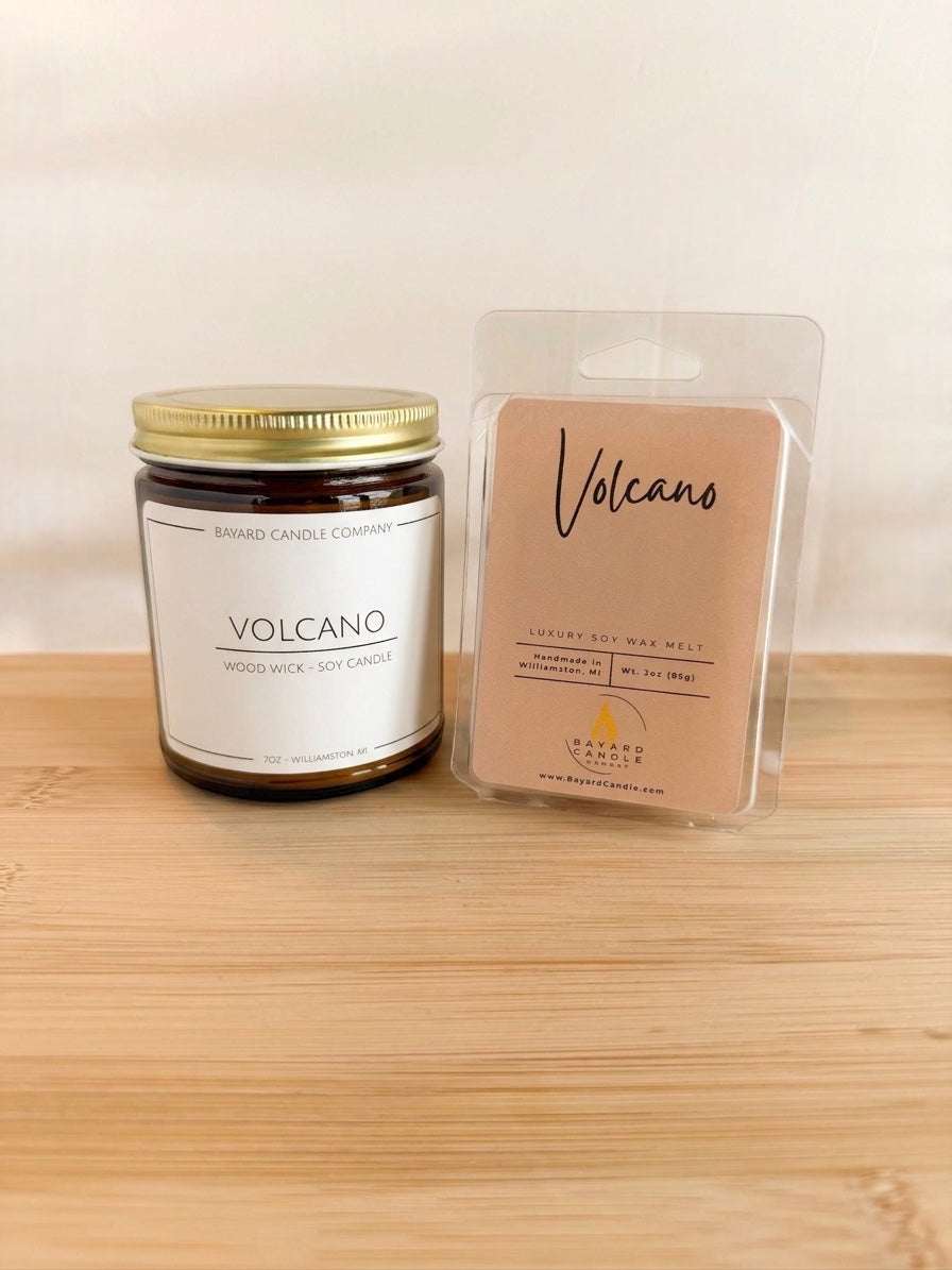 Volcano wood wick soy candle with matching wax melt set on wood surface