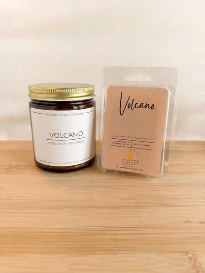 Volcano wood wick soy candle with matching wax melt set on wood surface