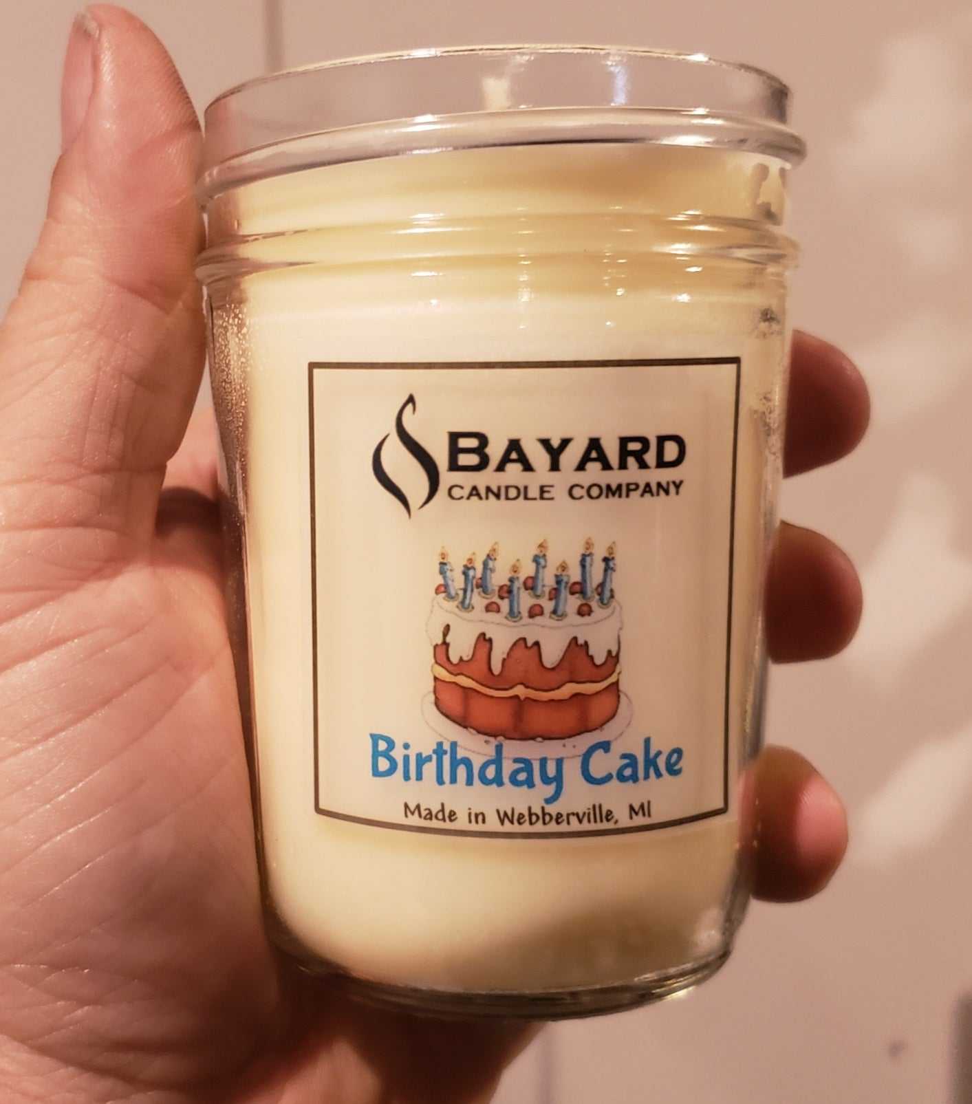 Birthday Cake Soy Candle in a hand
